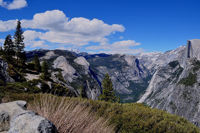 Panoramic view of landscape and mountains against blue sky