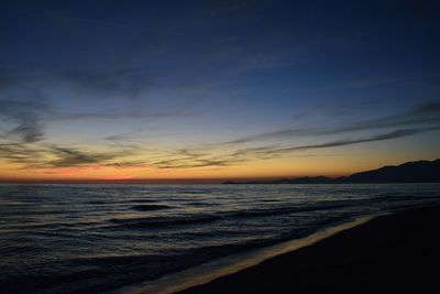 Scenic view of beach against sky during sunset