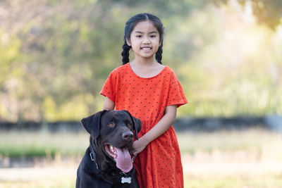 Portrait of cute girl with dog