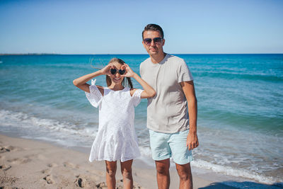 Friends standing at beach