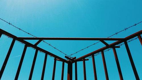 Low angle view of cables against clear blue sky