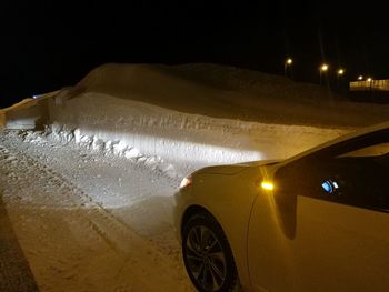 Illuminated car against sky at night