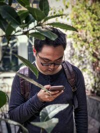 Young man using mobile phone outdoors