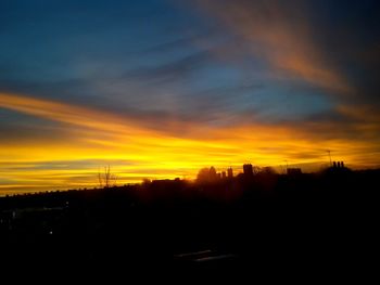 Silhouette of landscape against dramatic sky