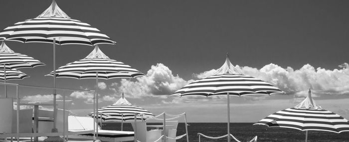 Umbrellas on beach against sky