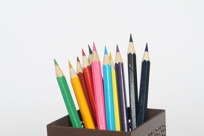 Close-up of colored pencils against white background