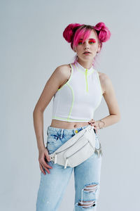 Young woman standing against white background