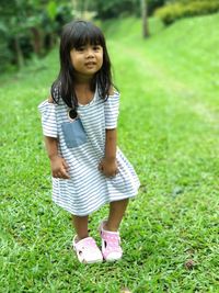 Cute girl standing on grass