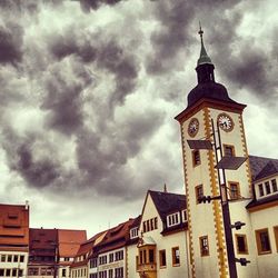 Low angle view of building against cloudy sky