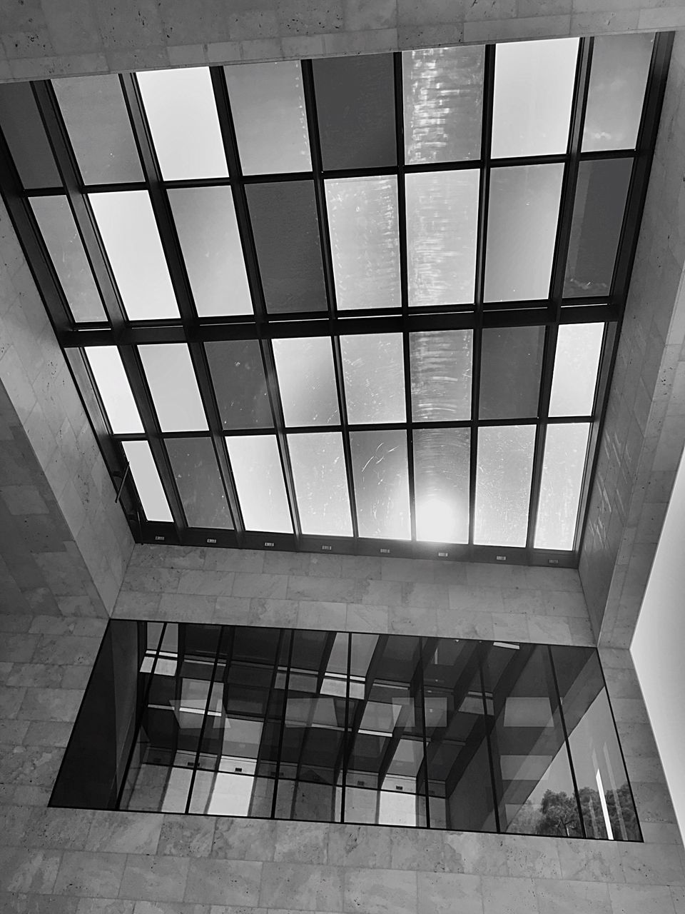 LOW ANGLE VIEW OF GLASS WINDOWS IN BUILDING