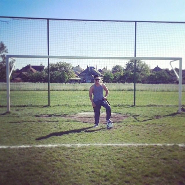 full length, grass, lifestyles, tree, leisure activity, childhood, rear view, casual clothing, field, park - man made space, standing, green color, walking, sport, day, men, clear sky, boys