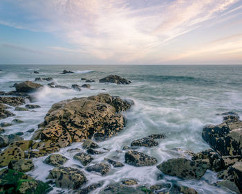 Scenic view of sea against sky at sunset