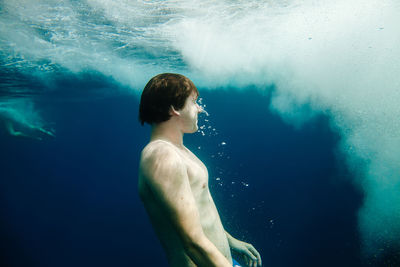 Mid adult woman swimming undersea