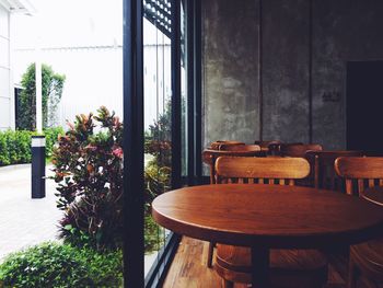 Empty chairs and table by window at home