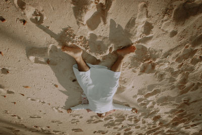 Low section of man standing at beach