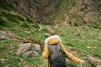 Rear view of man walking on mountain