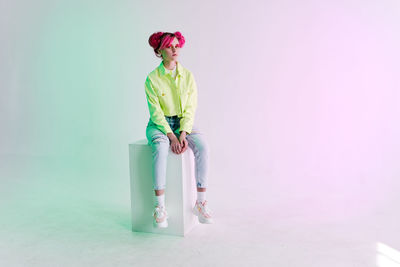 Rear view of woman standing against white background