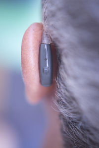 Close-up of man using hearing aid