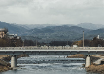 Bridge over mountains against sky