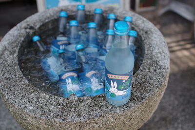 High angle view of bottles on rock