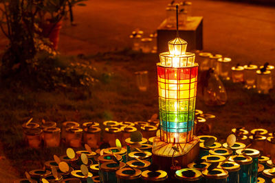 Close-up of illuminated lamp on table at night