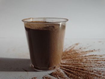 Close-up of coffee in drinking glass on table