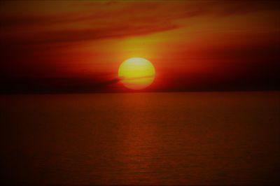 Scenic view of sea against orange sky