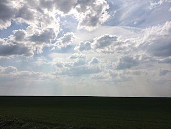 Scenic view of landscape against cloudy sky