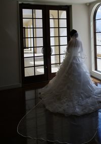 Man and woman standing by window
