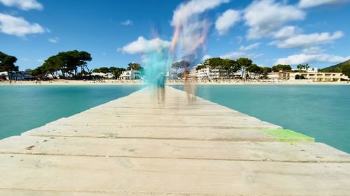 View of swimming pool by sea against sky