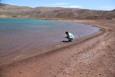 Man sitting on shore