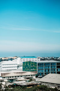 Scenic view of sea against buildings in city