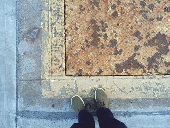 Low section of person standing on tiled floor