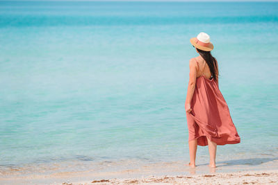 Full length of woman standing on beach