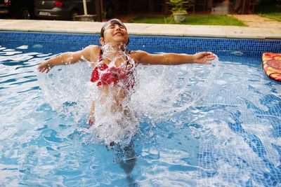 Cheerful girl in swimming pool