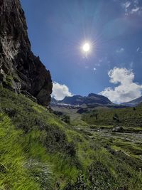 Scenic view of landscape against bright sun
