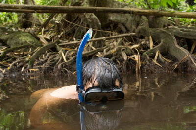 High angle view of shirtless man snorkeling in lake