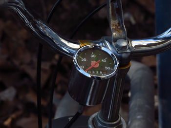 Close-up of speedometer connected to bicycle