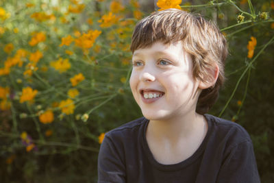 Smiling boy against flowers