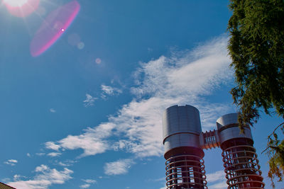 Low angle view of smoke stack against sky