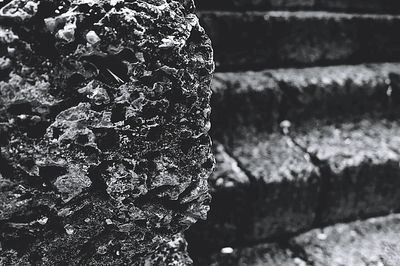 Close-up of stone wall with steps in background