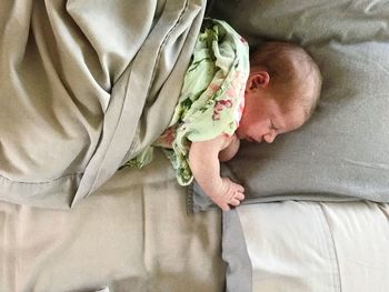High angle view of man sleeping on bed