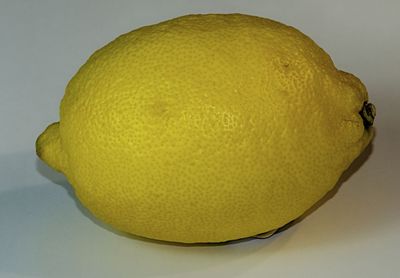 Close-up of yellow fruit against white background