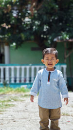 Portrait of cute boy standing outdoors