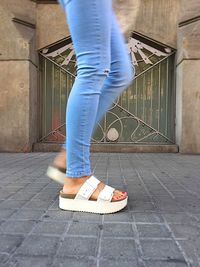 Low section of woman walking on floor