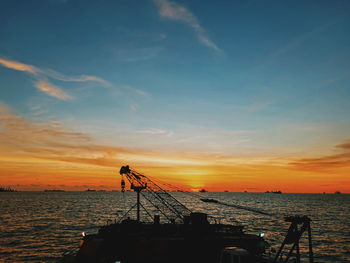 Silhouette vessel during sunset