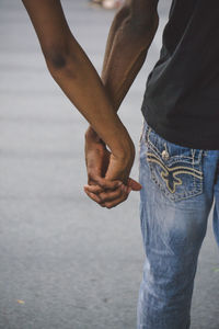 Cropped hand of woman holding man hand