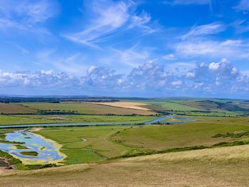 Scenic view of farm against sky