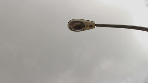 Low angle view of street light against sky