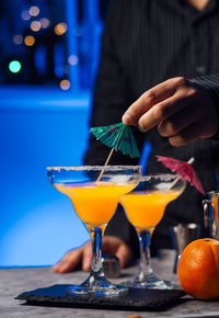 Waiter in a bar is preparing a cocktail